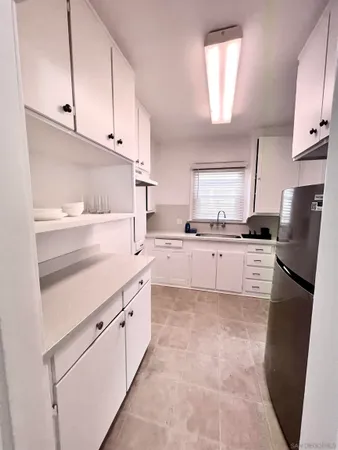 a kitchen with stainless steel appliances granite countertop a refrigerator sink and cabinets