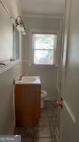 a bathroom with a sink toilet and vanity