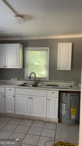 a kitchen with a sink and cabinets
