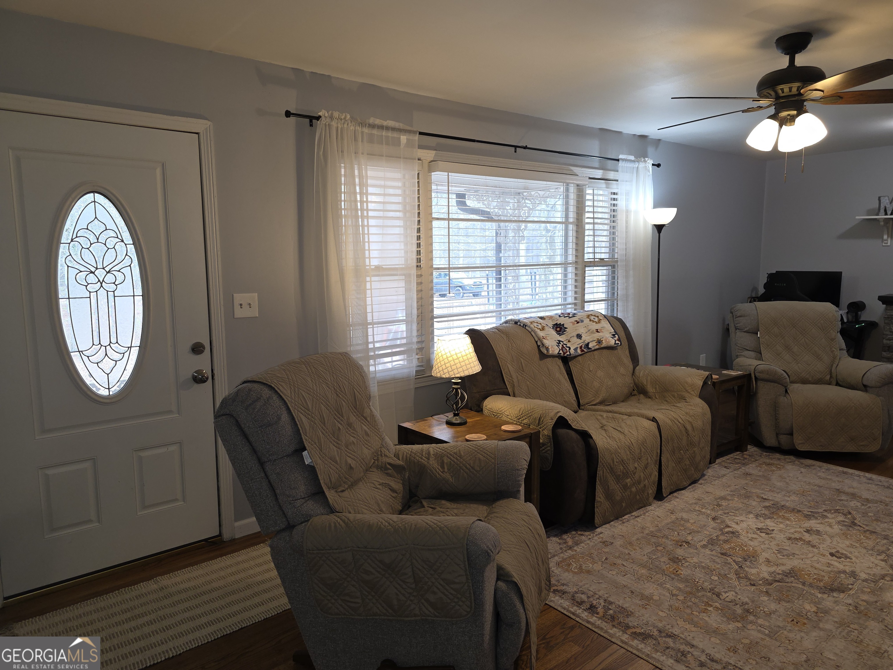 731 Seabreeze Lake Road Buchanan, GA 30113 - Photo 13 of 34 a living room with furniture a window and a chandelier