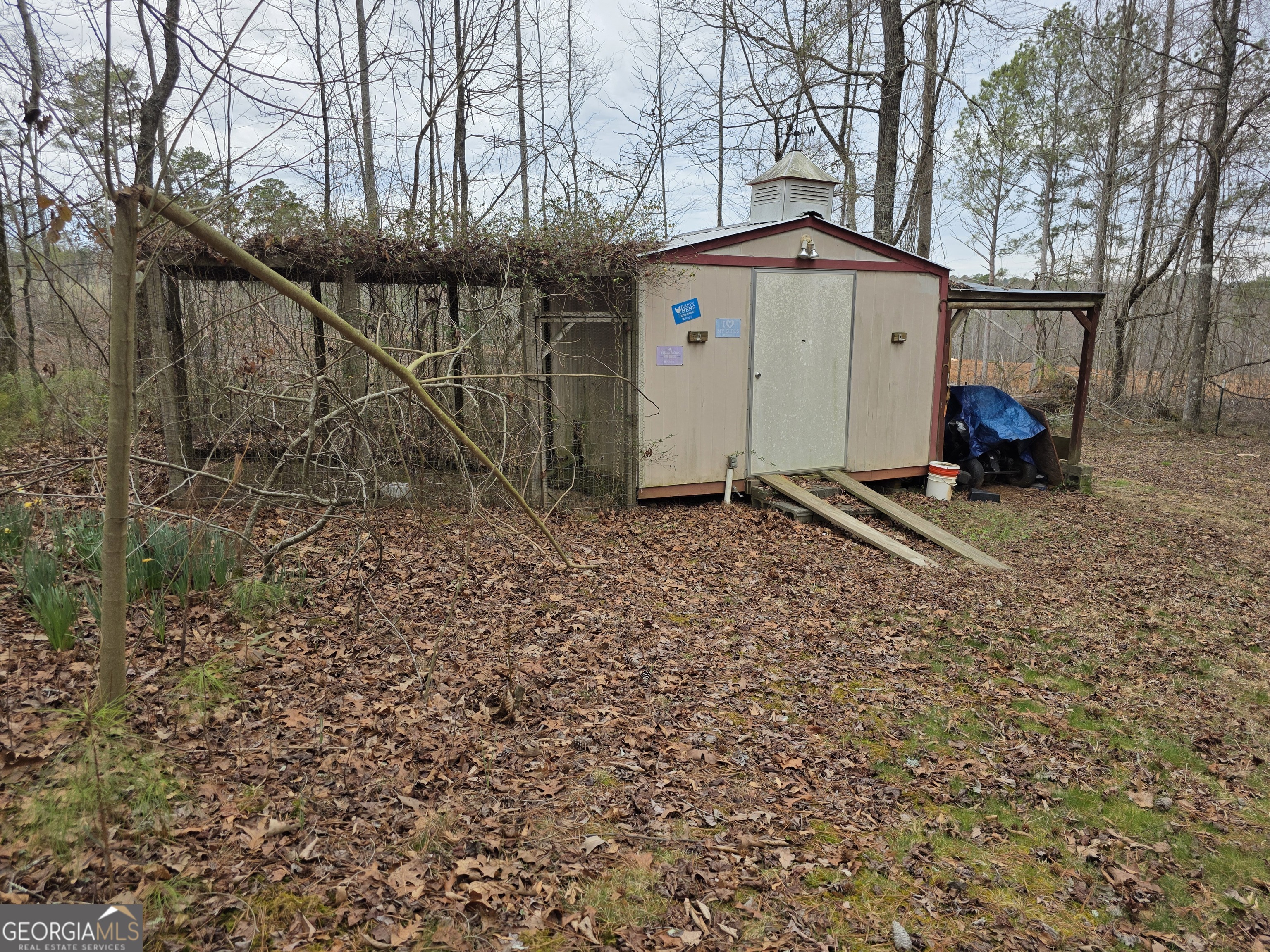 731 Seabreeze Lake Road Buchanan, GA 30113 - Photo 30 of 34 a backyard of a house with barbeque oven table and chairs