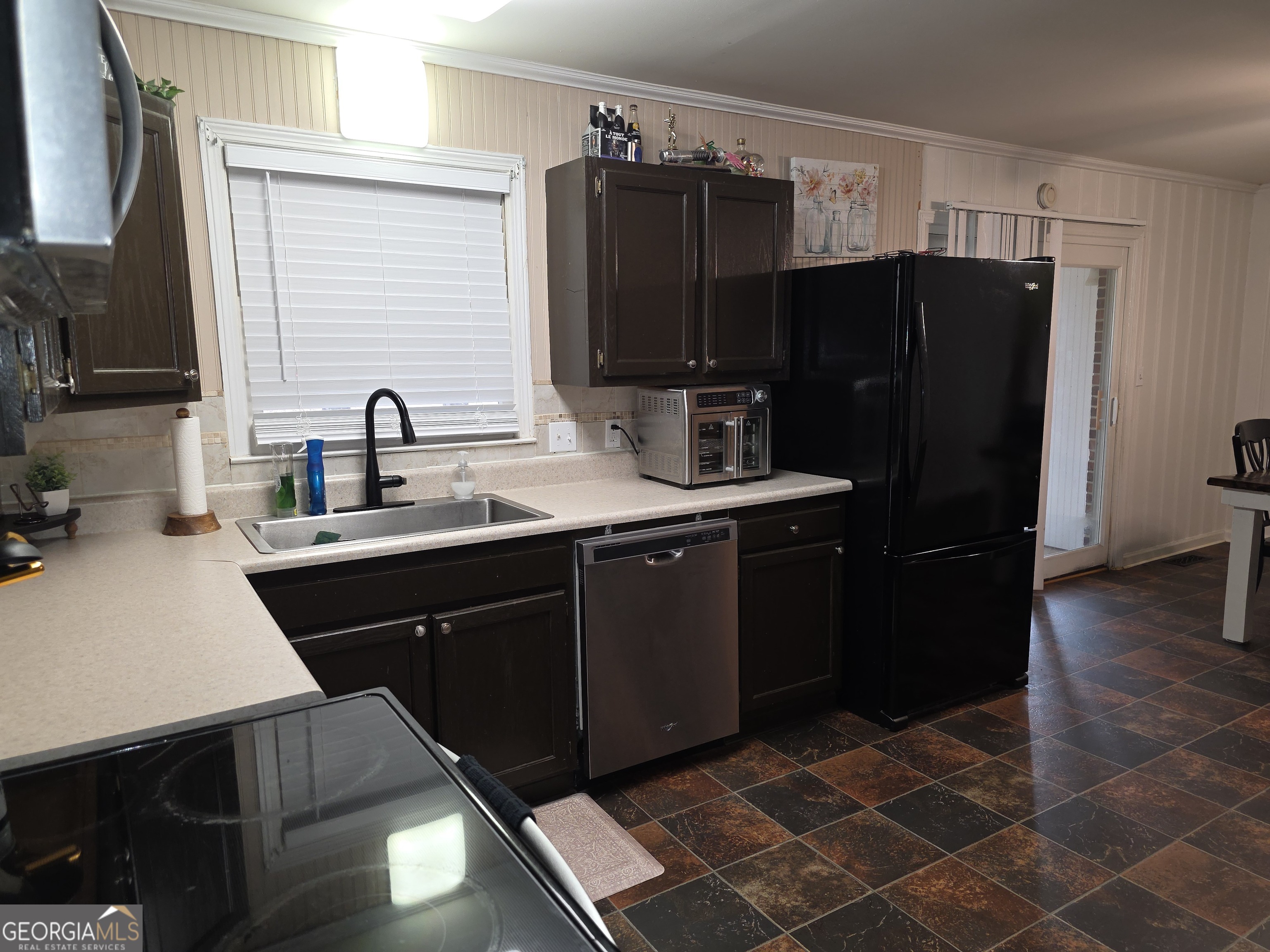 731 Seabreeze Lake Road Buchanan, GA 30113 - Photo 6 of 34 a kitchen with a sink a refrigerator and cabinets
