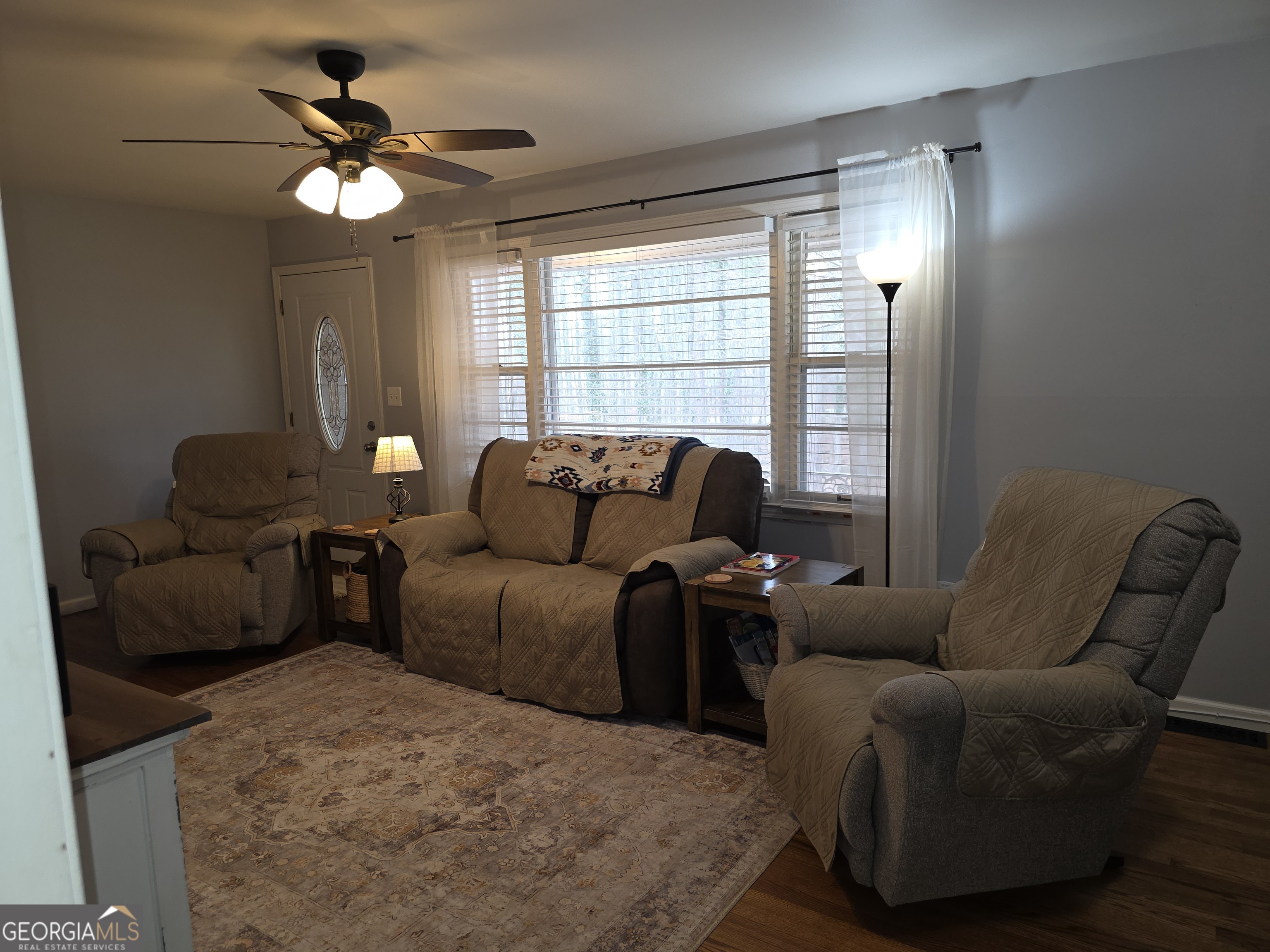 731 Seabreeze Lake Road Buchanan, GA 30113 - Photo 10 of 34 a living room with furniture and a large window