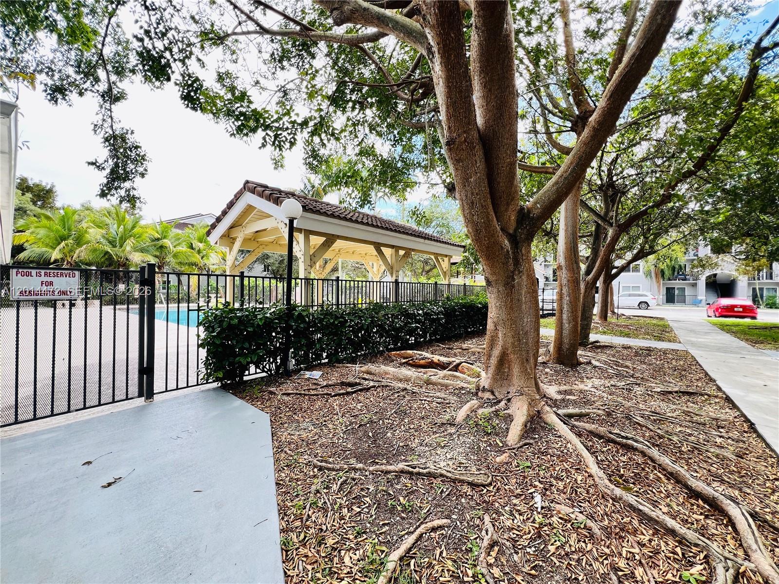 15410 Southwest 284th Street, Unit 8102 Homestead, FL 33033 - Photo 13 of 18 a view of a house with a tree in the yard