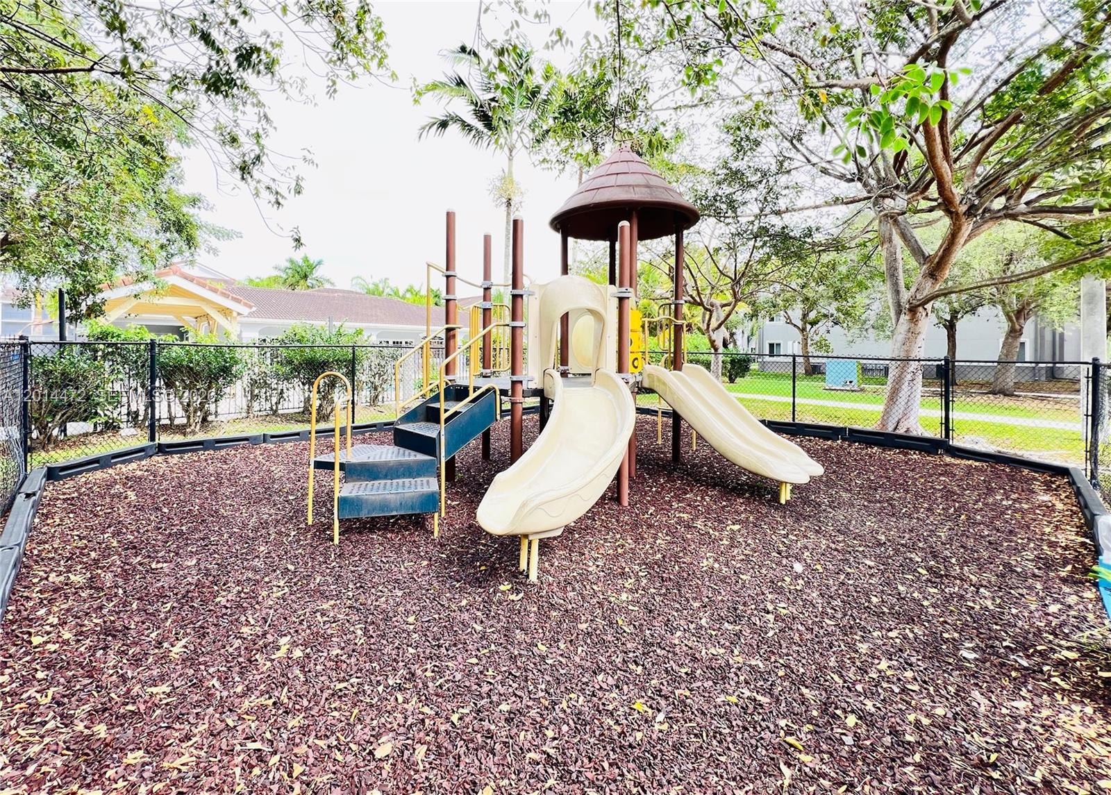 15410 Southwest 284th Street, Unit 8102 Homestead, FL 33033 - Photo 14 of 18 a view of a yard with furniture and a garden