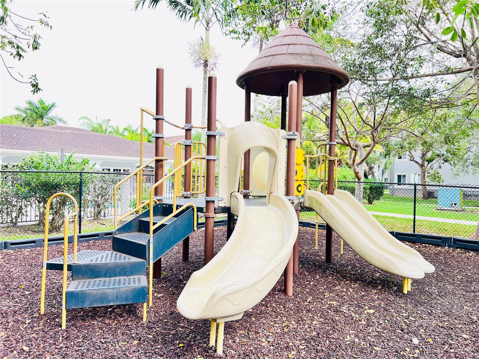 15410 Southwest 284th Street, Unit 8102 Homestead, FL 33033 - Photo 15 of 18 a view of a swimming pool with a patio and a yard