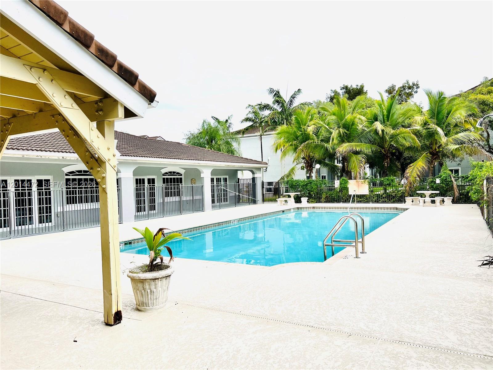 15410 Southwest 284th Street, Unit 8102 Homestead, FL 33033 - Photo 16 of 18 a view of house with swimming pool outdoor seating