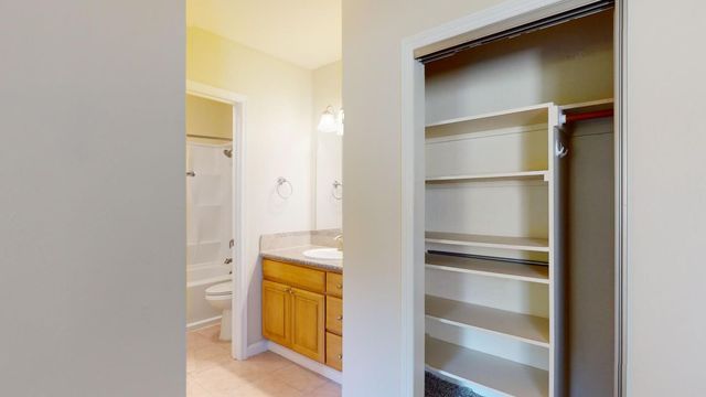 a view of walk in closet with empty racks