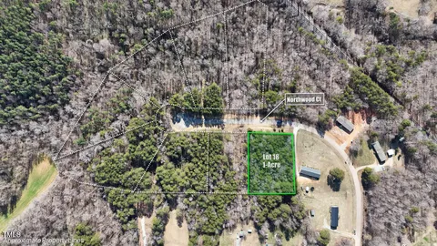 an aerial view of house with yard and car parked