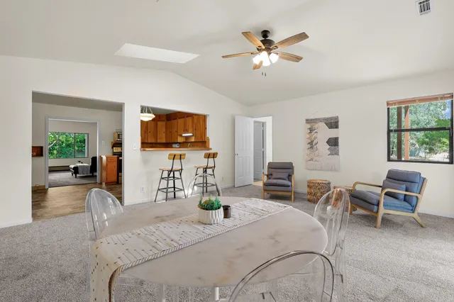 a bedroom with a bed a chandelier and a flat screen tv