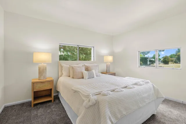 a bedroom with a bed and a painting on the wall