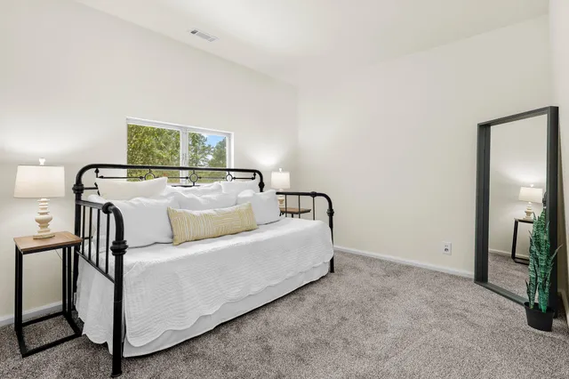 a living room with a couch and a dresser