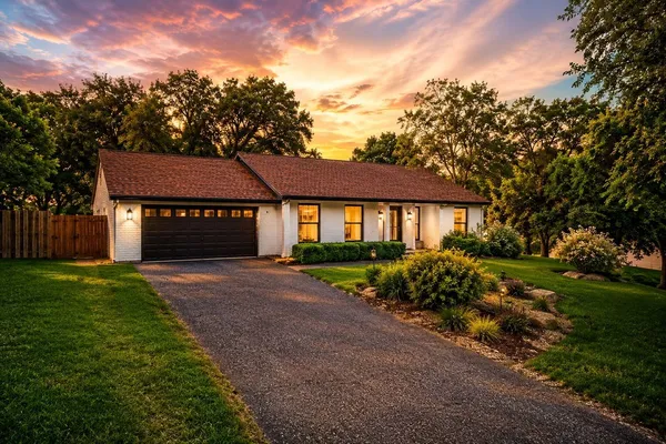 a front view of a house with a garden