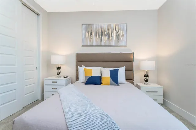 a bedroom with a large bed and a chandelier