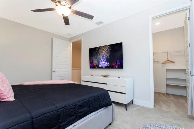 a bedroom with a bed and a ceiling fan