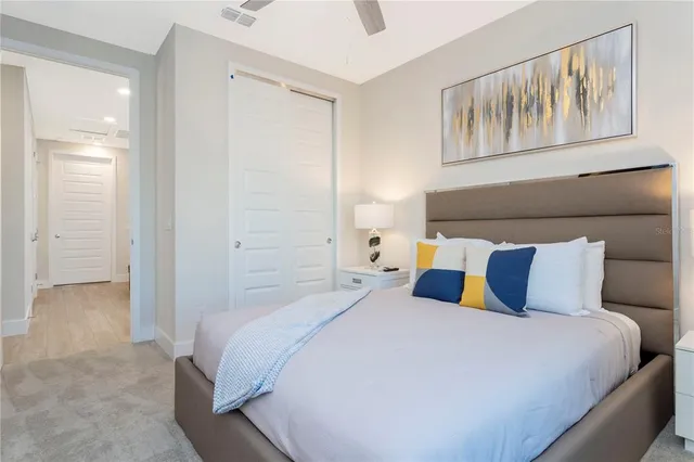 a bedroom with a bed and painting on the wall