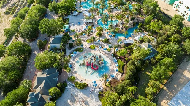 an aerial view of a residential houses with yard