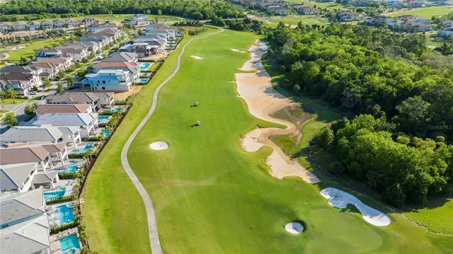 an aerial view of a residential houses with outdoor space and swimming pool