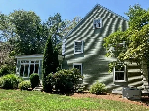 a view of a house with a yard and plants