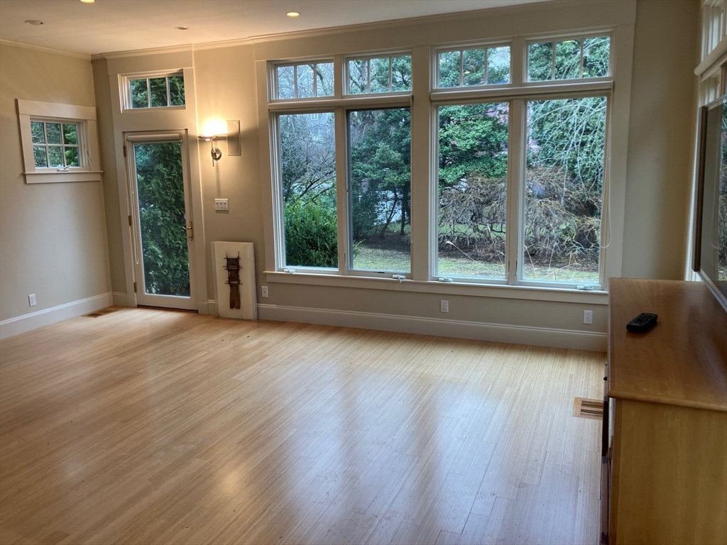 3 Glenoe Road Brookline, MA 02467 - Photo 5 of 12 a view of empty room with wooden floor and fan