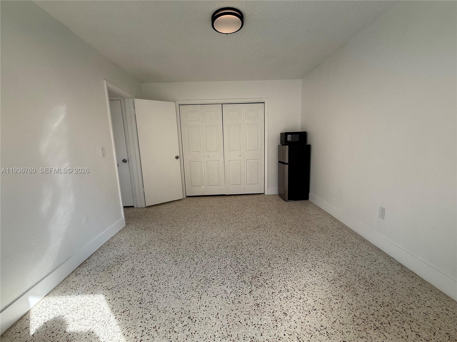 3144 Northwest 29th Street, Unit 1 Miami, FL 33142 - Photo 2 of 6 a view of a livingroom with an empty space