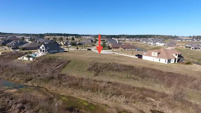 an aerial view of a house with a mountain