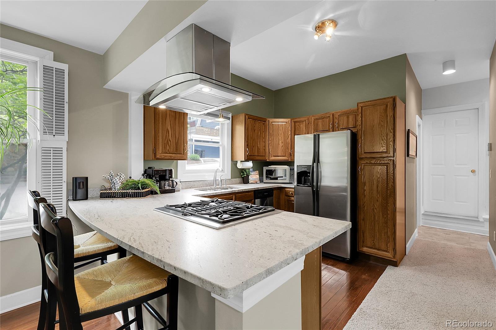 503 15th Street Golden, CO 80401 - Photo 10 of 30 a kitchen with stainless steel appliances granite countertop a table chairs and a refrigerator