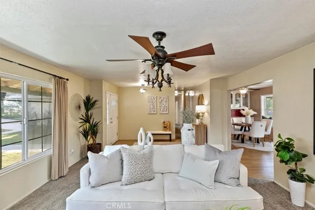 a view of a dining room with furniture a chandelier and wooden floor