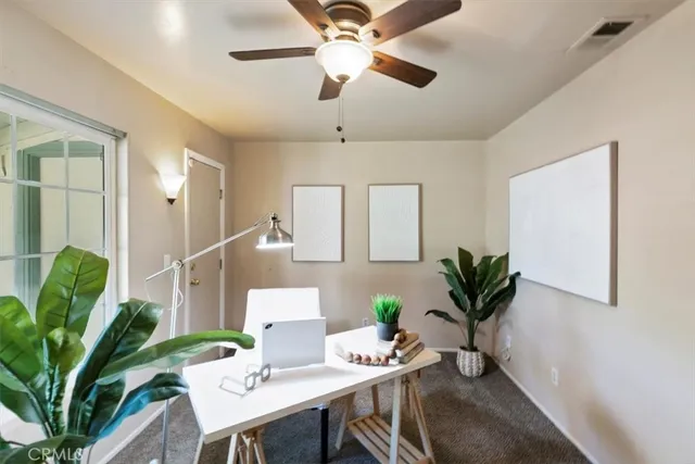 a bedroom with a bed potted plant and a window