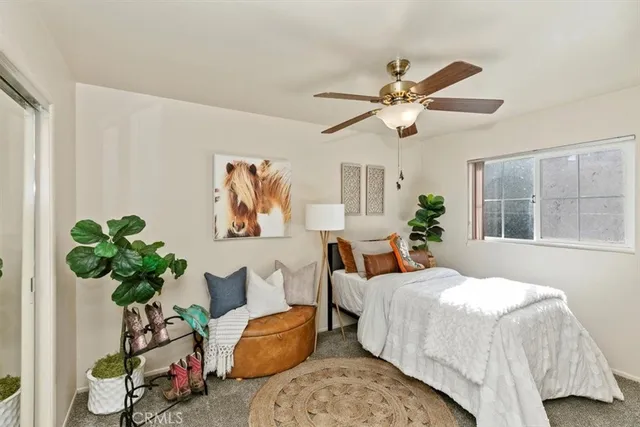 a spacious bedroom with a bed and glass door