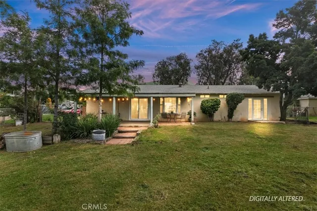 a big yard with lots of green space and fountain