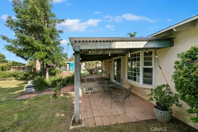 a backyard of a house with table and chairs