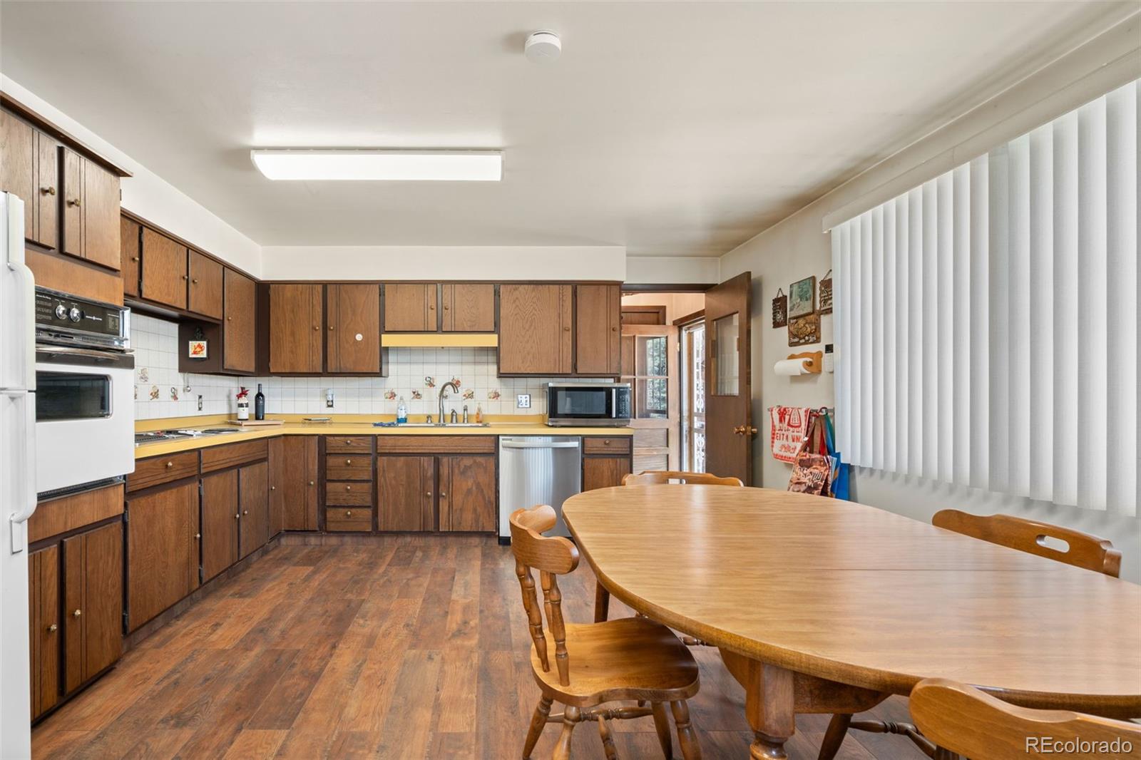5410 Indiana Street Golden, CO 80403 - Photo 11 of 50 a kitchen with a table chairs sink and cabinets