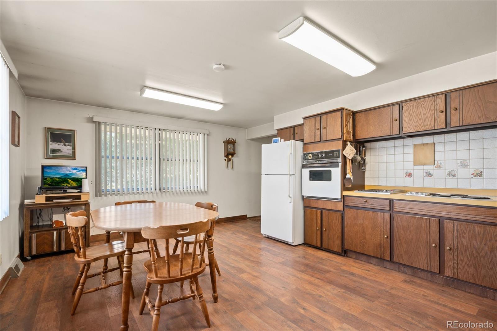 5410 Indiana Street Golden, CO 80403 - Photo 13 of 50 a kitchen with stainless steel appliances granite countertop a stove top oven a sink dishwasher and a refrigerator