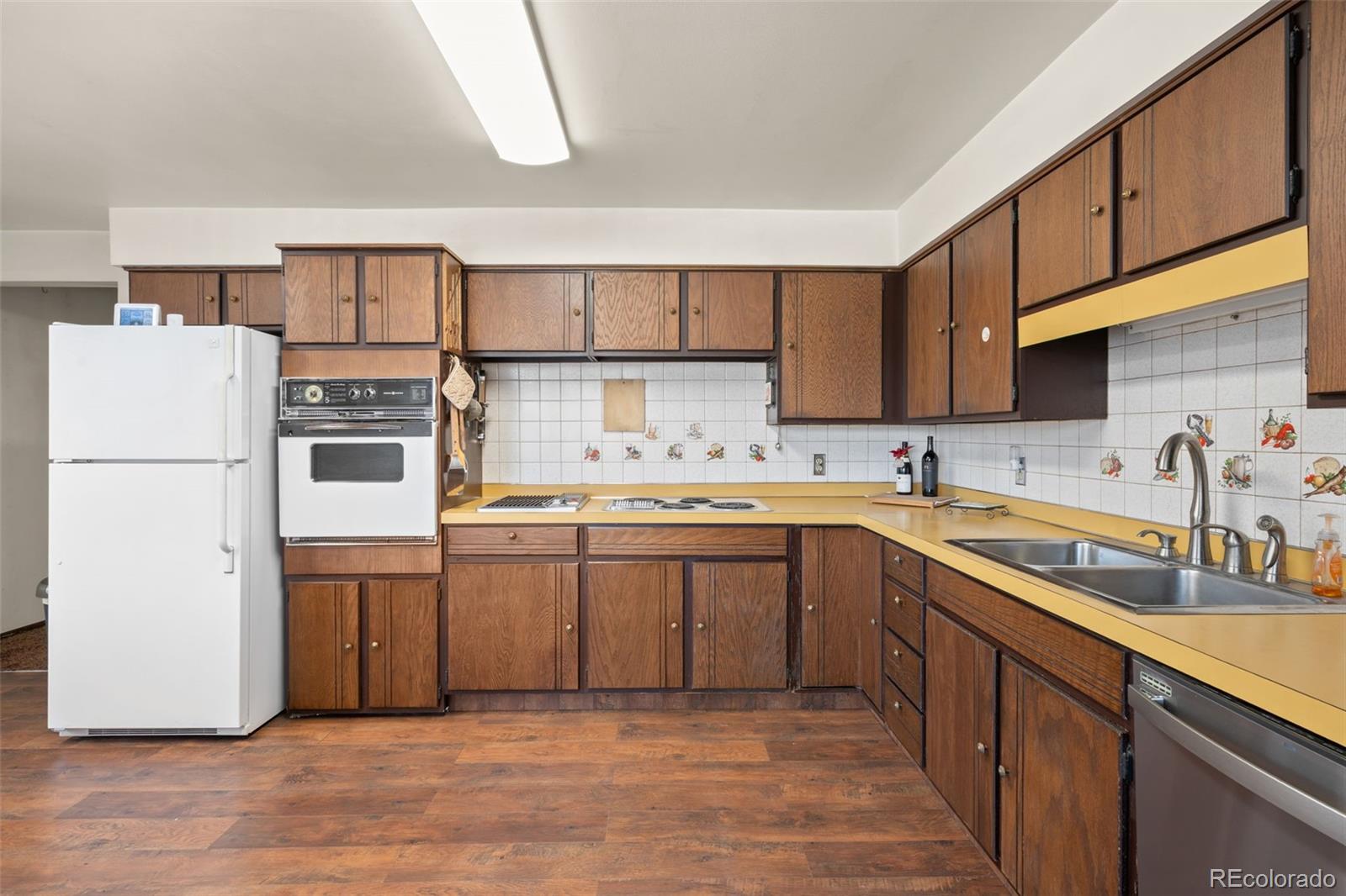 5410 Indiana Street Golden, CO 80403 - Photo 14 of 50 a kitchen with stainless steel appliances granite countertop a refrigerator sink and cabinets