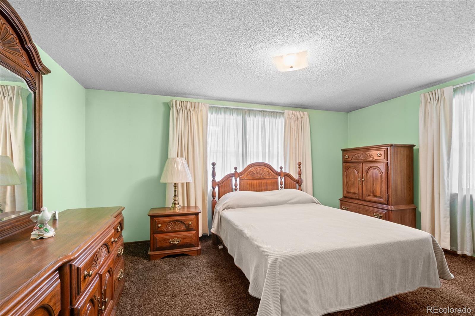 5410 Indiana Street Golden, CO 80403 - Photo 16 of 50 a bedroom with a bed and a dresser next to a window