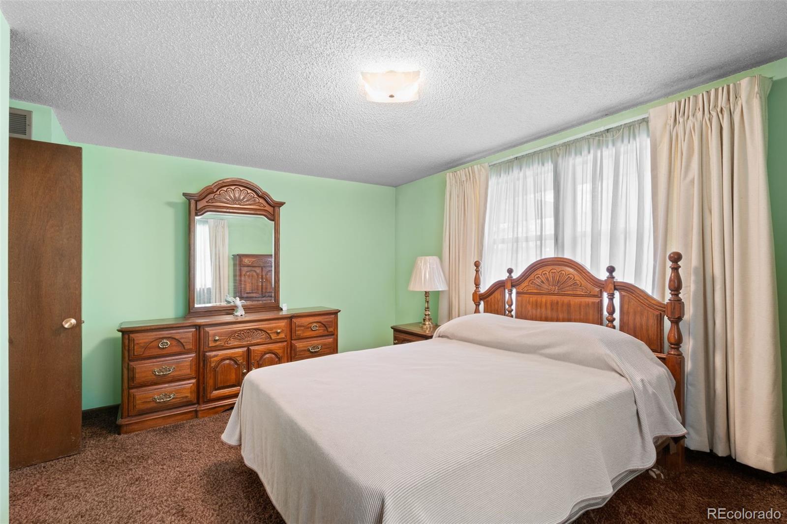 5410 Indiana Street Golden, CO 80403 - Photo 18 of 50 a bedroom with a bed and a dresser