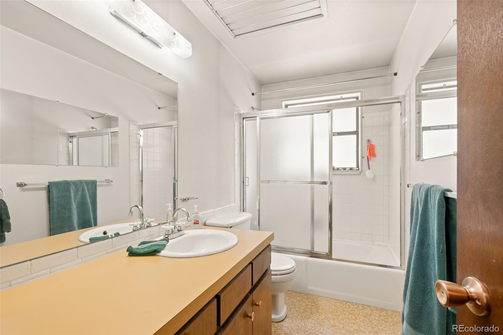 5410 Indiana Street Golden, CO 80403 - Photo 19 of 50 a bathroom with a tub sink and mirror