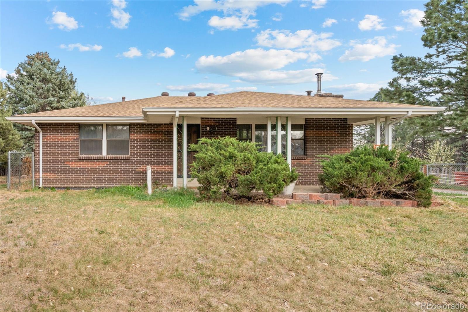 5410 Indiana Street Golden, CO 80403 - Photo 2 of 50 a front view of a house with garden