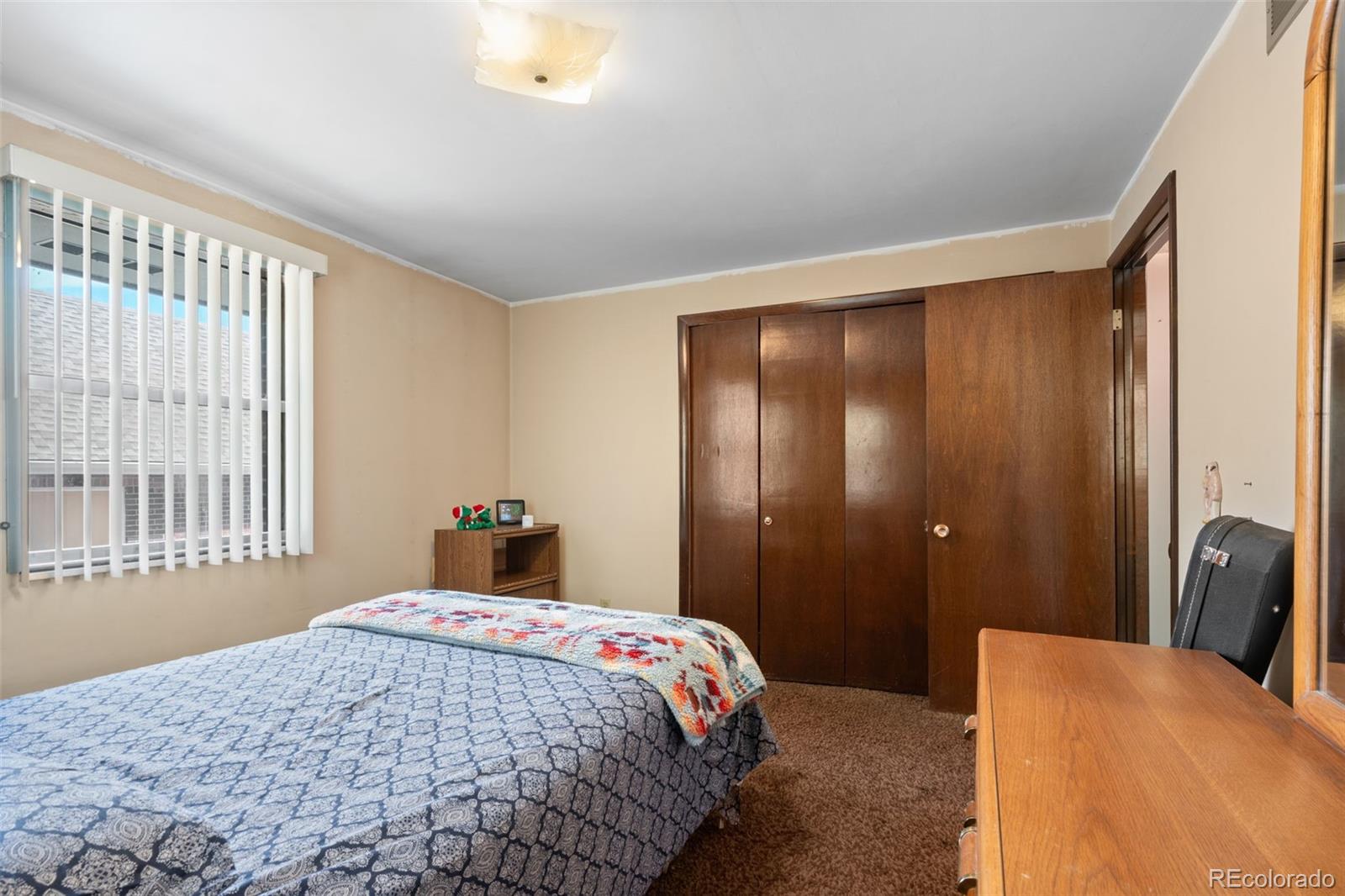 5410 Indiana Street Golden, CO 80403 - Photo 21 of 50 a bedroom with a bed and wooden floor