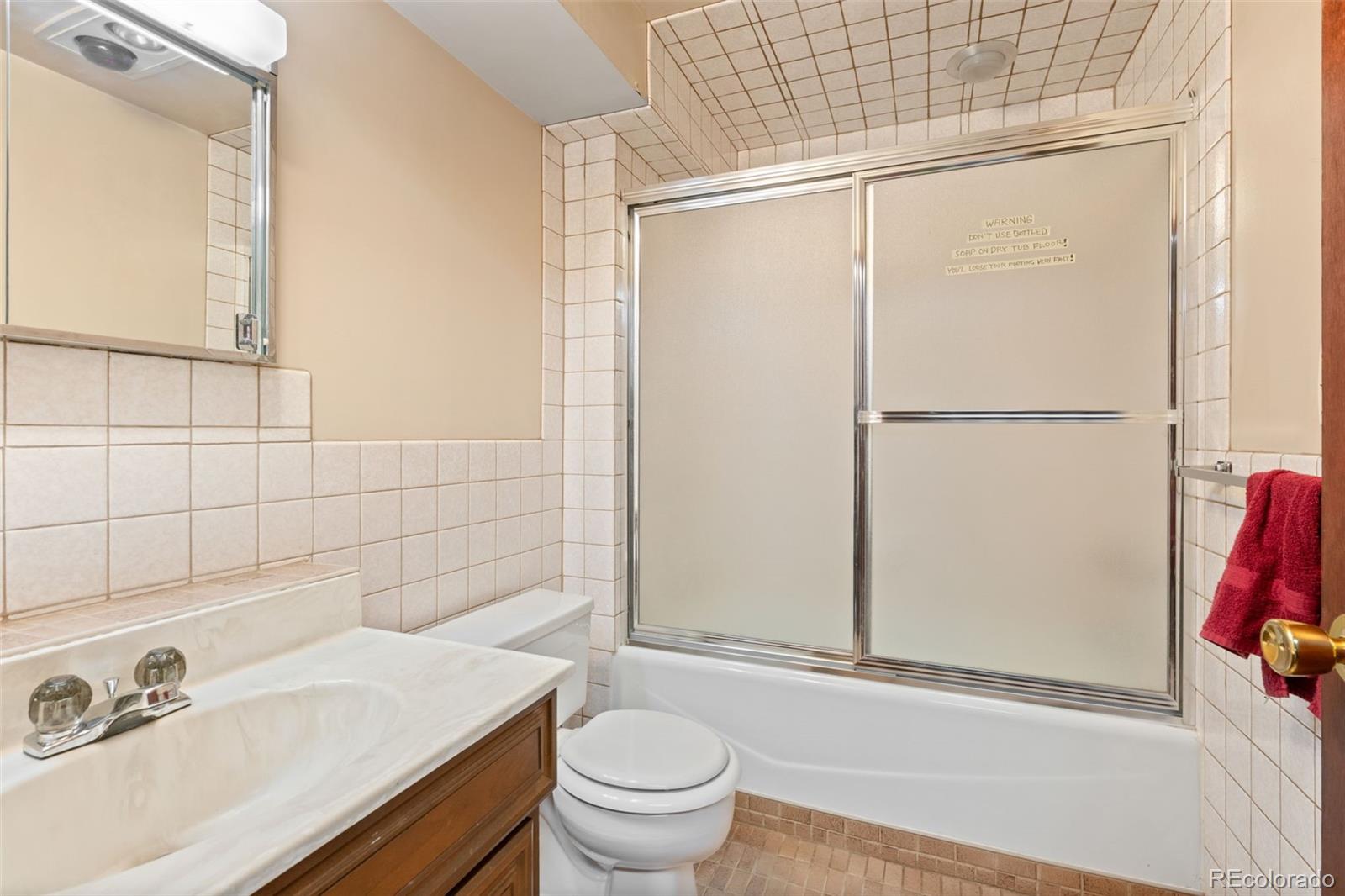 5410 Indiana Street Golden, CO 80403 - Photo 22 of 50 a bathroom with a sink a toilet and shower