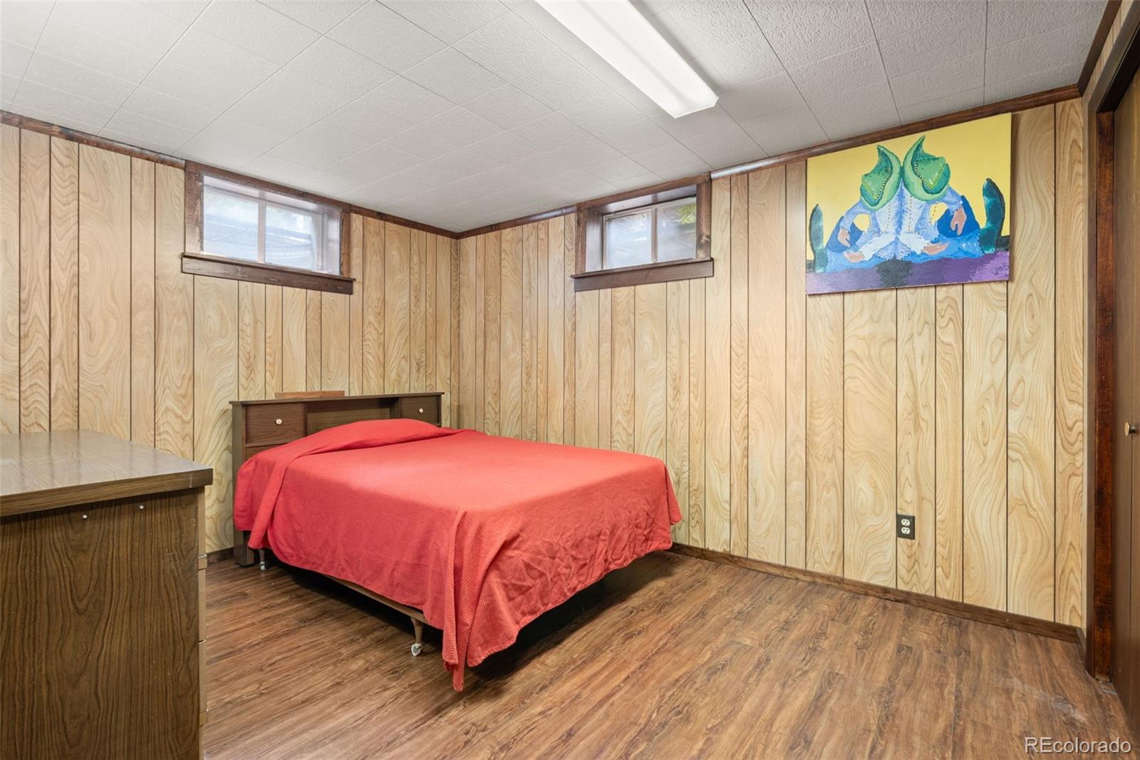 5410 Indiana Street Golden, CO 80403 - Photo 24 of 50 a bedroom with a bed and a painting on the wall