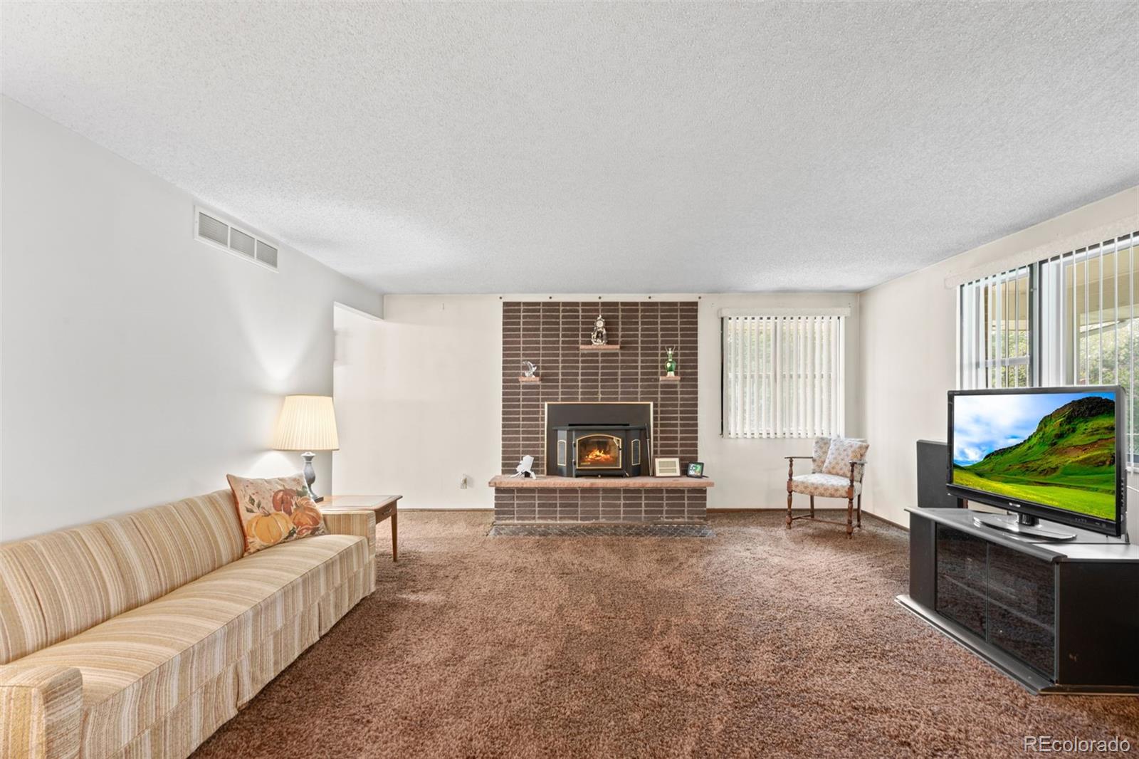 5410 Indiana Street Golden, CO 80403 - Photo 5 of 50 a living room with furniture and a flat screen tv