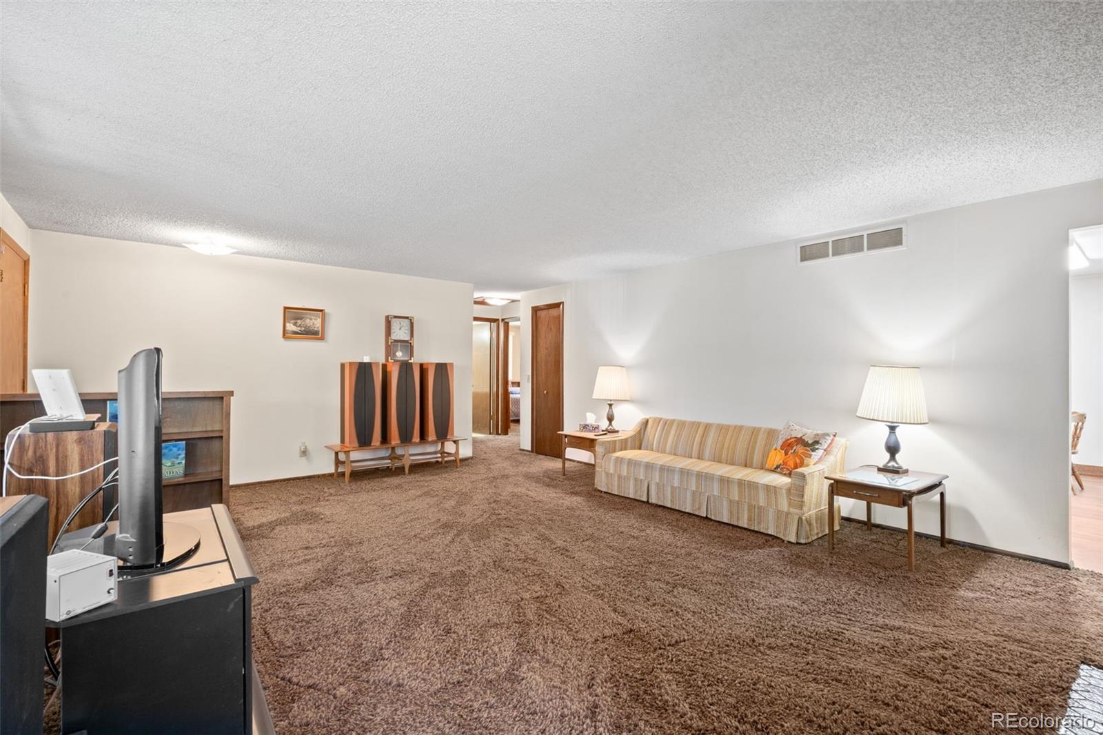 5410 Indiana Street Golden, CO 80403 - Photo 9 of 50 a living room with furniture and a flat screen tv