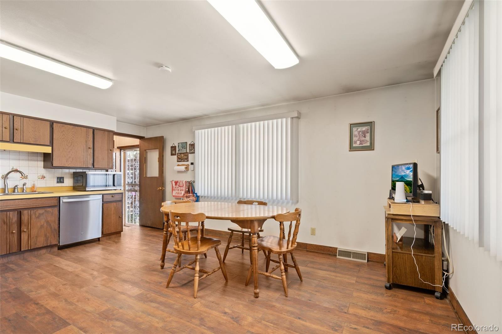 5410 Indiana Street Golden, CO 80403 - Photo 10 of 50 a view of a dining room with furniture and wooden floor