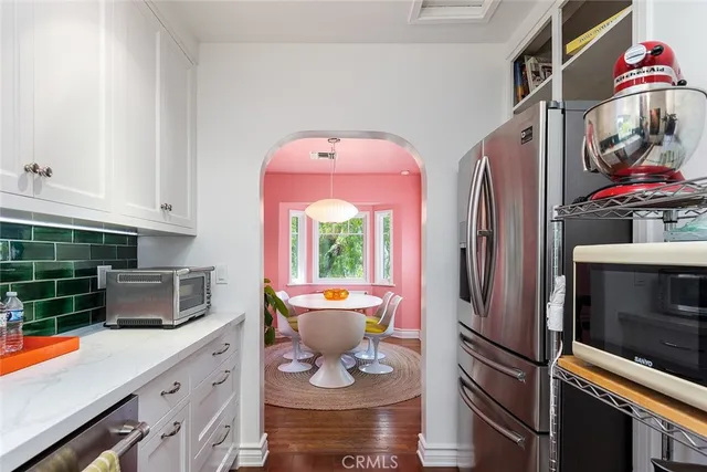a kitchen with stainless steel appliances granite countertop a refrigerator and a stove