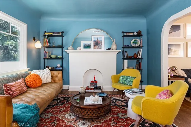 a living room with furniture fireplace and window