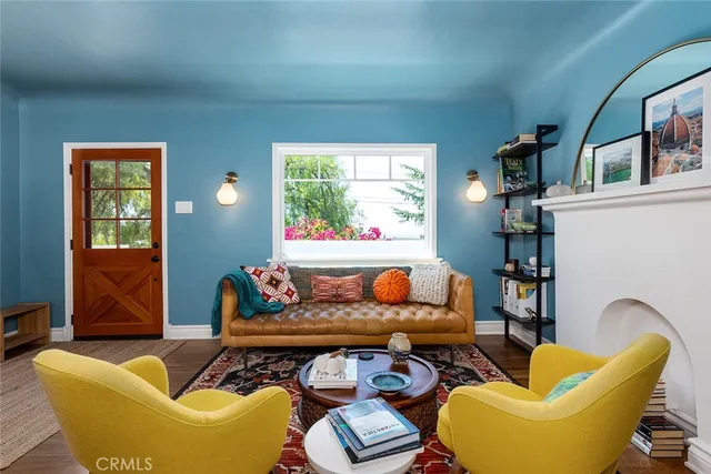 a living room with furniture a rug and a window