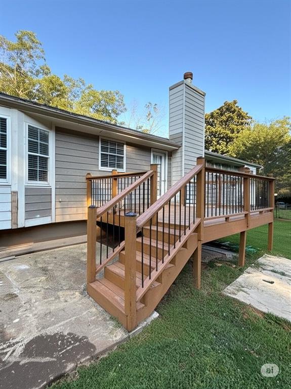 2851 Stanton Road Southeast Conyers, GA 30094 - Photo 2 of 11 a view of a deck with a table and chair under an umbrella