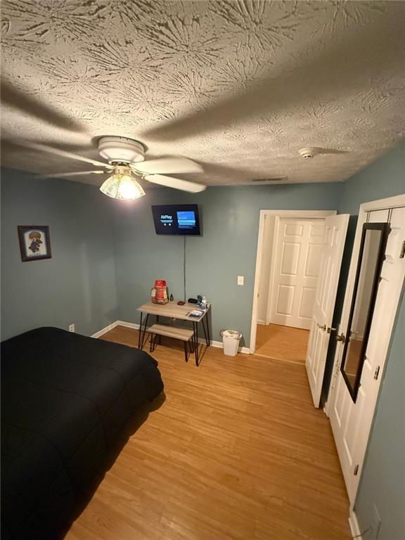 2851 Stanton Road Southeast Conyers, GA 30094 - Photo 6 of 11 a bedroom with a bed and a flat tv screen on dresser